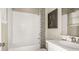 Clean bathroom featuring a tub/shower combo, modern fixtures, and neutral decor at 5626 Portico Pl, Kissimmee, FL 34758