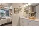 Bright bathroom with double vanity, quartz countertops and direct access to main bedroom at 5626 Portico Pl, Kissimmee, FL 34758