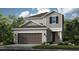 Charming two-story home with neutral siding, a two-car garage, and well-maintained landscaping at 5626 Portico Pl, Kissimmee, FL 34758