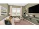 Stylish home office with a built-in desk, comfortable seating, and lots of natural light at 5626 Portico Pl, Kissimmee, FL 34758