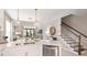 Modern kitchen with stainless appliances, white countertops, a stainless steel dishwasher, and staircase access at 5626 Portico Pl, Kissimmee, FL 34758