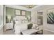 Serene bedroom with a tray ceiling, neutral paint, and a view into the ensuite bathroom at 5626 Portico Pl, Kissimmee, FL 34758