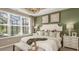 Comfortable bedroom with large windows, neutral tones, and stylish furnishings overlooking the pool at 5626 Portico Pl, Kissimmee, FL 34758