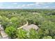 Aerial view of the home surrounded by lush greenery and trees at 5836 Spruce Creek Woods Dr, Port Orange, FL 32127