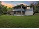 A view of the home's backyard including a screened-in porch and deck at 5836 Spruce Creek Woods Dr, Port Orange, FL 32127