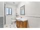 Bright bathroom with tile floor, mosaic accent, and vanity with wooden cabinets at 5836 Spruce Creek Woods Dr, Port Orange, FL 32127