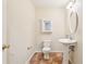 Bathroom with a white pedestal sink and updated fixtures at 5836 Spruce Creek Woods Dr, Port Orange, FL 32127