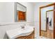 Bathroom with undermount sink and view to open door at 5836 Spruce Creek Woods Dr, Port Orange, FL 32127