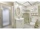 Quaint bathroom with walk-in shower, pedestal sink, and decorative wallpaper at 5836 Spruce Creek Woods Dr, Port Orange, FL 32127