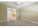 Bedroom featuring carpeting and a view into the kitchen at 5836 Spruce Creek Woods Dr, Port Orange, FL 32127