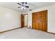 Bedroom with carpet flooring, closet, and ceiling fan at 5836 Spruce Creek Woods Dr, Port Orange, FL 32127