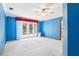 Bright bedroom with a ceiling fan, white carpet, and glass doors to a deck at 5836 Spruce Creek Woods Dr, Port Orange, FL 32127