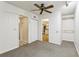 Bedroom featuring carpeting, closet, view of a bathroom and view into another room at 5836 Spruce Creek Woods Dr, Port Orange, FL 32127