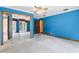 Large bedroom with blue walls, white carpet, fan and closet at 5836 Spruce Creek Woods Dr, Port Orange, FL 32127