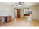 This bedroom features wood floors, a ceiling fan, and mirrored closet doors at 5836 Spruce Creek Woods Dr, Port Orange, FL 32127
