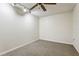 Empty bedroom with neutral carpeting and a ceiling fan and track lighting at 5836 Spruce Creek Woods Dr, Port Orange, FL 32127