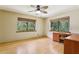 Bedroom with two windows with wooded view and laminate floor at 5836 Spruce Creek Woods Dr, Port Orange, FL 32127