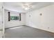 Minimalist bedroom features neutral carpet, a window and simple design at 5836 Spruce Creek Woods Dr, Port Orange, FL 32127