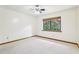 Bright bedroom with carpet, ceiling fan, and large window view at 5836 Spruce Creek Woods Dr, Port Orange, FL 32127