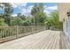 Expansive wood deck with railing, surrounded by lush tropical foliage, offering ample space for outdoor enjoyment at 5836 Spruce Creek Woods Dr, Port Orange, FL 32127