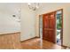 Inviting foyer with hardwood floors and a wooden front door, leading to the living spaces at 5836 Spruce Creek Woods Dr, Port Orange, FL 32127