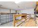 Spacious garage featuring ample storage options with wooden shelving and a unique overhead lift at 5836 Spruce Creek Woods Dr, Port Orange, FL 32127