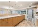 Open concept kitchen with light wood cabinetry, breakfast bar and seamless access to living areas at 5836 Spruce Creek Woods Dr, Port Orange, FL 32127