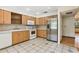 Kitchen with stainless steel refrigerator, ample cabinetry, and tile flooring at 5836 Spruce Creek Woods Dr, Port Orange, FL 32127