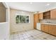 Kitchen featuring tile flooring and view to wooded outdoors at 5836 Spruce Creek Woods Dr, Port Orange, FL 32127