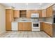 Updated kitchen with bright cabinets and white appliances at 5836 Spruce Creek Woods Dr, Port Orange, FL 32127