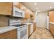 Well-equipped kitchen with modern appliances, abundant cabinet space, and easy-to-clean tile flooring at 5836 Spruce Creek Woods Dr, Port Orange, FL 32127
