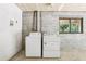 Laundry room area with washer and dryer hookups with a window for natural light at 5836 Spruce Creek Woods Dr, Port Orange, FL 32127