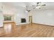 Spacious living room featuring hardwood floors, a cozy fireplace, and abundant natural light at 5836 Spruce Creek Woods Dr, Port Orange, FL 32127