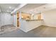 Inviting living space with access to the kitchen area, featuring modern lighting and sleek countertops at 5836 Spruce Creek Woods Dr, Port Orange, FL 32127