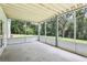 Screened patio offering a bright and airy space with views of the lush backyard at 5836 Spruce Creek Woods Dr, Port Orange, FL 32127