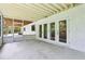 Covered patio with brick exterior and lots of natural light with a view into the backyard at 5836 Spruce Creek Woods Dr, Port Orange, FL 32127