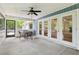 Covered porch with ceiling fan, table and chairs at 5836 Spruce Creek Woods Dr, Port Orange, FL 32127