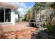 Private backyard showing brick pavers, lush plants, and a comfortable bench at 627 N Cherokee Ave, Deland, FL 32724