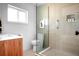 Modern bathroom showcasing a walk-in shower with glass and a floating wood vanity and a sleek neutral design at 627 N Cherokee Ave, Deland, FL 32724