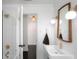 Modern bathroom with a sleek white sink, gold fixtures, and a shower with white tiling at 627 N Cherokee Ave, Deland, FL 32724