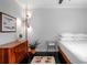 Charming bedroom with hardwood floors, stylish lighting, and a sleek mid-century modern dresser at 627 N Cherokee Ave, Deland, FL 32724