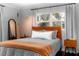 Cozy bedroom featuring modern decor, light-colored walls, and ample natural light from the window to create a relaxing ambiance at 627 N Cherokee Ave, Deland, FL 32724