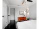 Bright bedroom featuring hardwood floors, a ceiling fan, and a modern lamp for a cozy ambiance at 627 N Cherokee Ave, Deland, FL 32724