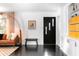 Light-filled entryway featuring a modern front door, built-in shelving, and elegant furnishings at 627 N Cherokee Ave, Deland, FL 32724