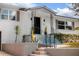 Charming home featuring a quaint front entrance with decorative iron railings and well-maintained landscaping at 627 N Cherokee Ave, Deland, FL 32724