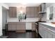 Well-lit kitchen with modern appliances, gray cabinets, subway tile backsplash, and dark hardwood floors at 627 N Cherokee Ave, Deland, FL 32724