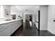 Bright, open kitchen with sleek white countertops, gray cabinets, and a clear view into the dining area at 627 N Cherokee Ave, Deland, FL 32724