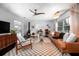 Bright living room featuring a leather sofa, fireplace, and view into the office at 627 N Cherokee Ave, Deland, FL 32724