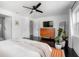Spacious main bedroom featuring dark wood floors, modern lighting, with convenient access to the ensuite bathroom at 627 N Cherokee Ave, Deland, FL 32724