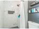 Modern bathroom shower featuring elegant marble tile and black hexagonal floor and niche accents at 636 Milan Dr, Kissimmee, FL 34758
